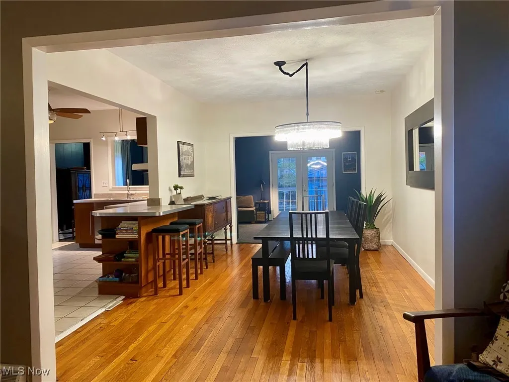 Dining space with light wood finished floors and a ceiling fan