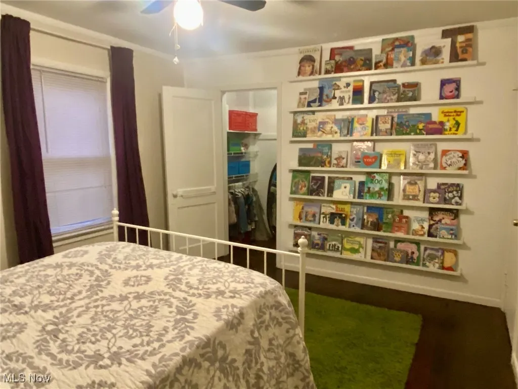 Bedroom featuring a ceiling fan and dark wood-style floors