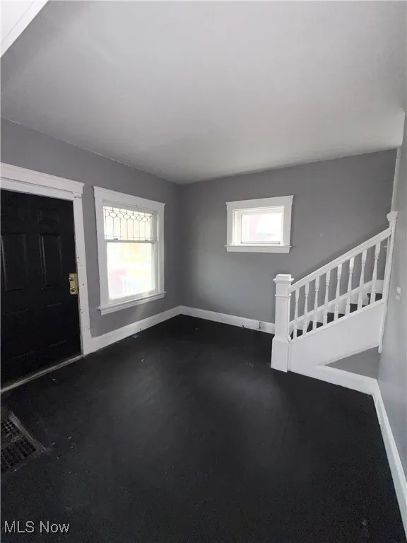 Entryway with healthy amount of natural light and stairs