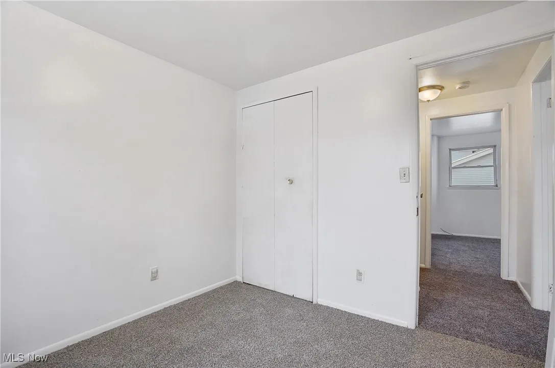 Unfurnished bedroom with carpet floors and a closet