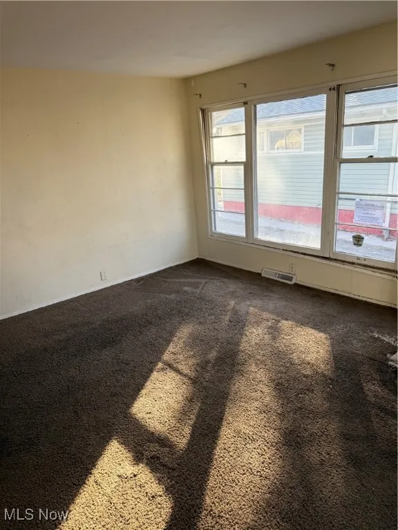 Spare room with dark carpet