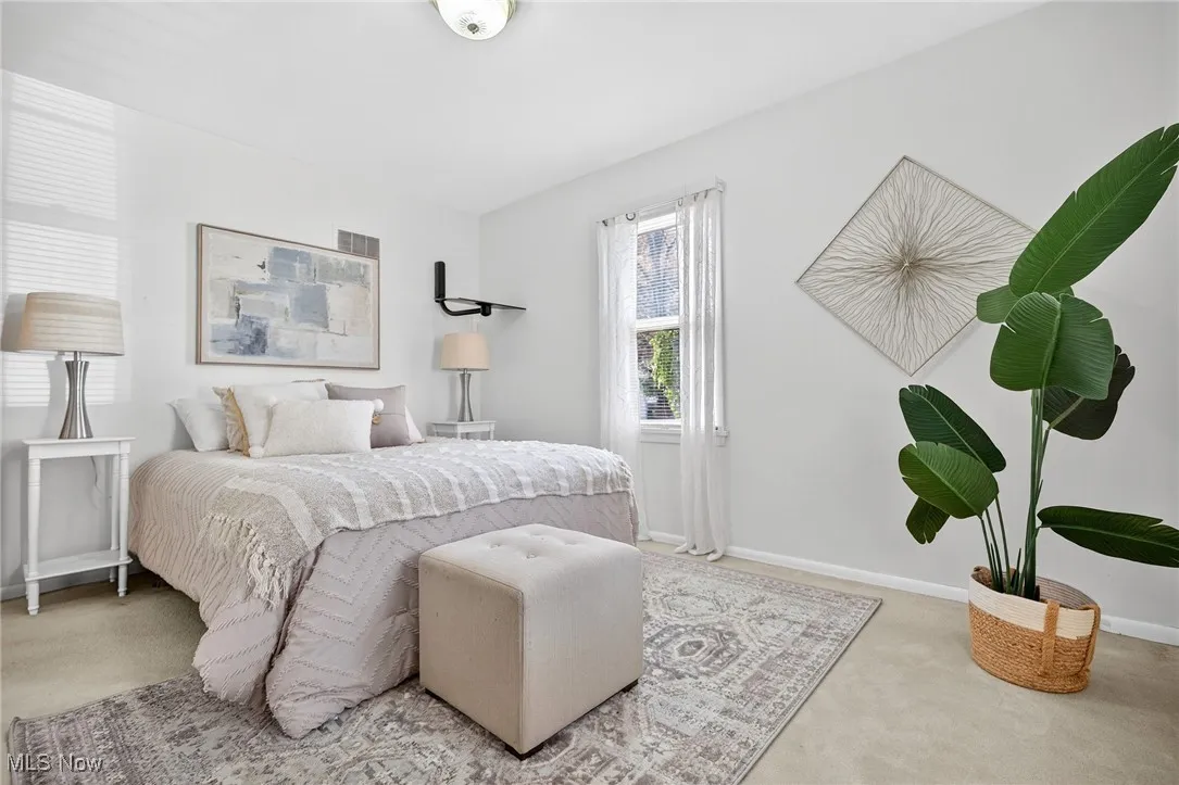 Bedroom featuring baseboards and carpet floors