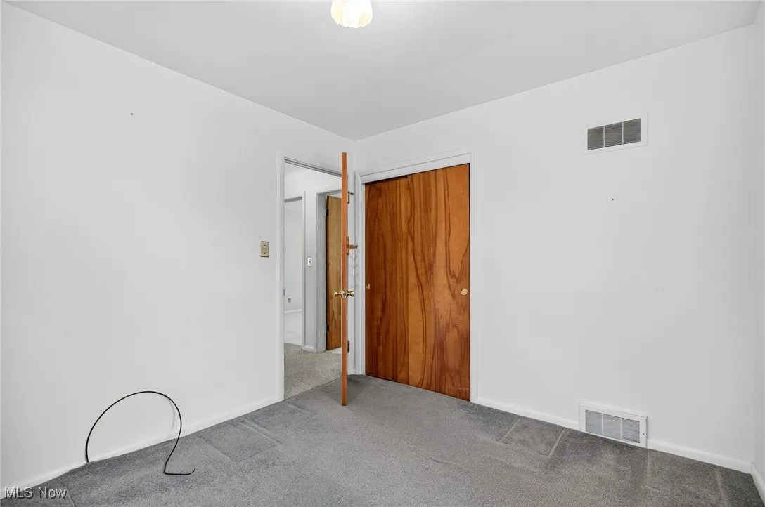 Unfurnished bedroom featuring a closet and carpet