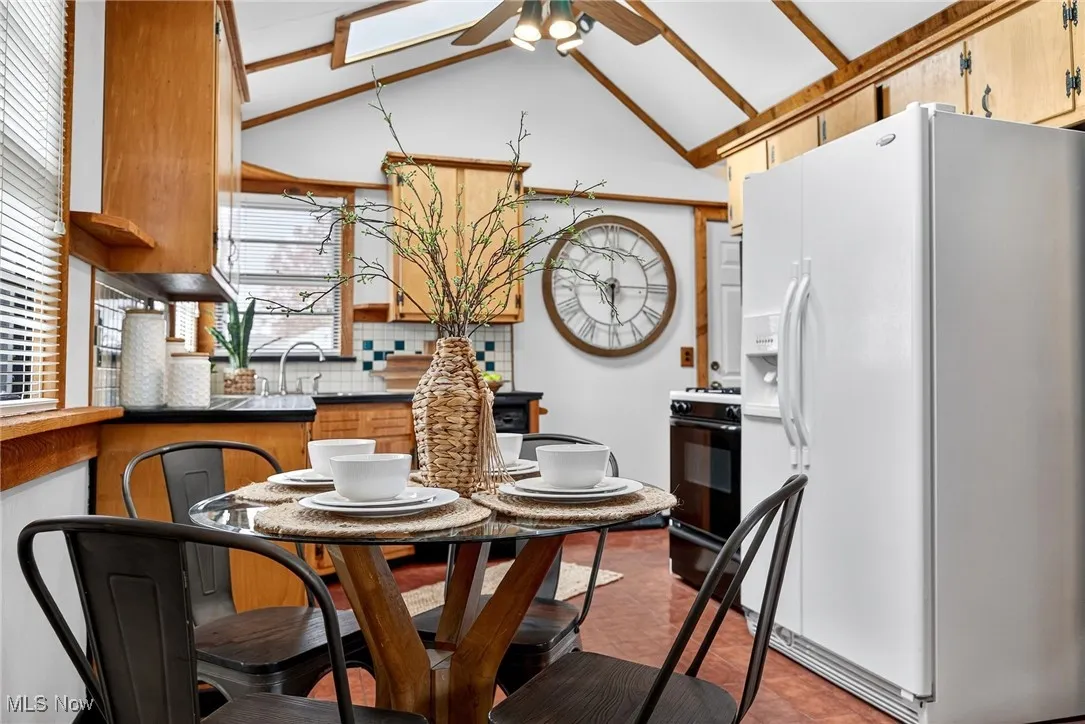 Dining room featuring lofted ceiling and ceiling fan