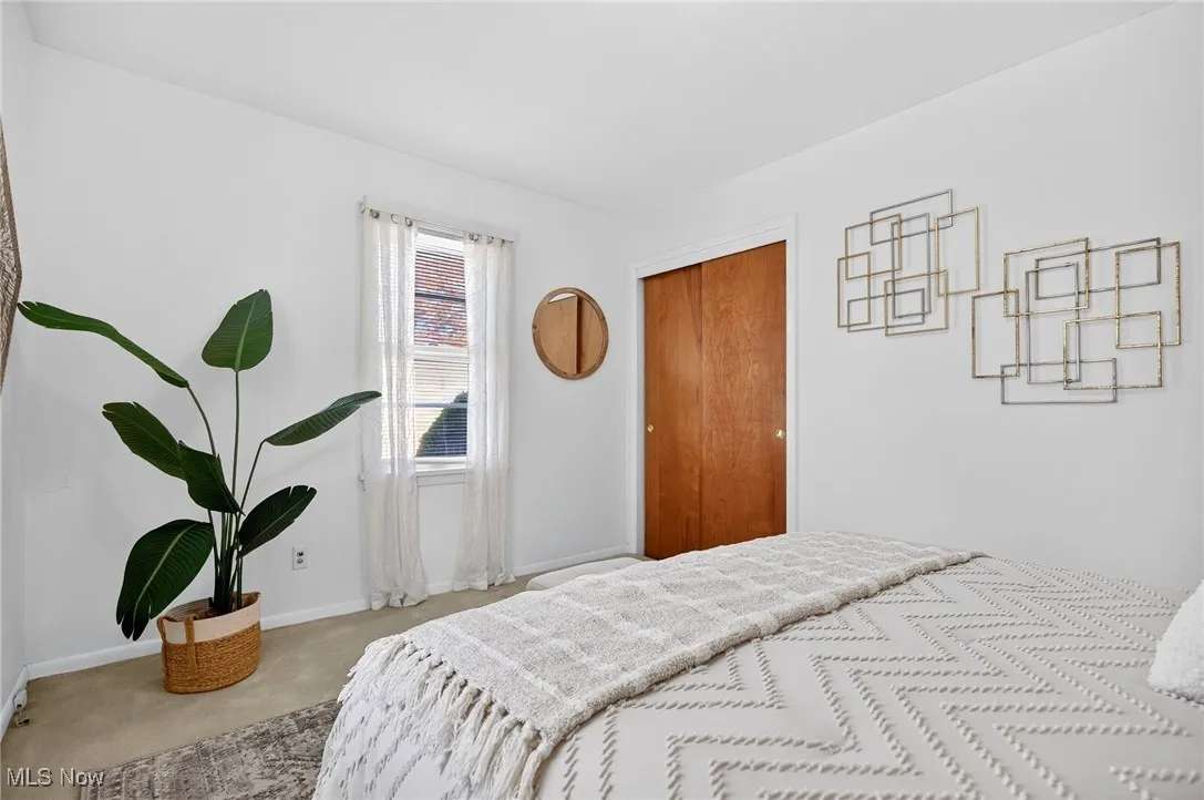 Bedroom with carpet floors and a closet