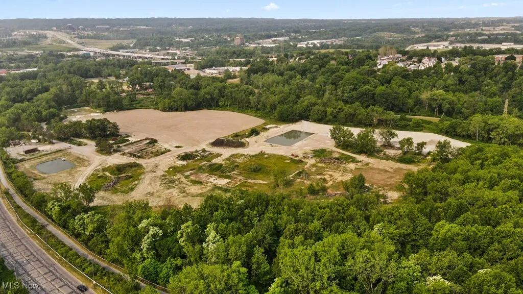 View of property location featuring a forest