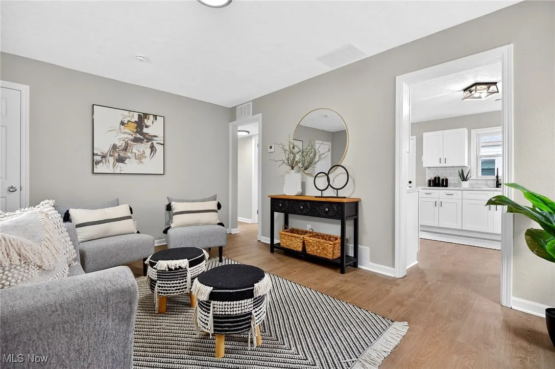 Living room featuring light wood-style flooring and baseboards