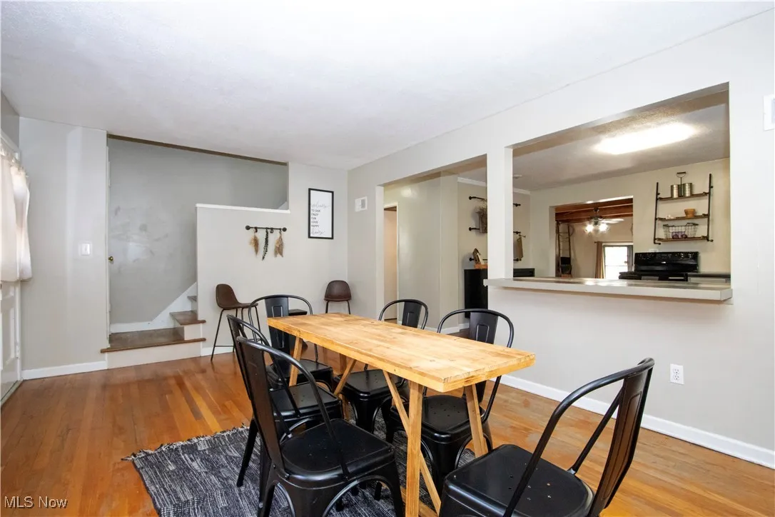Dining space with stairs and light wood-style floors