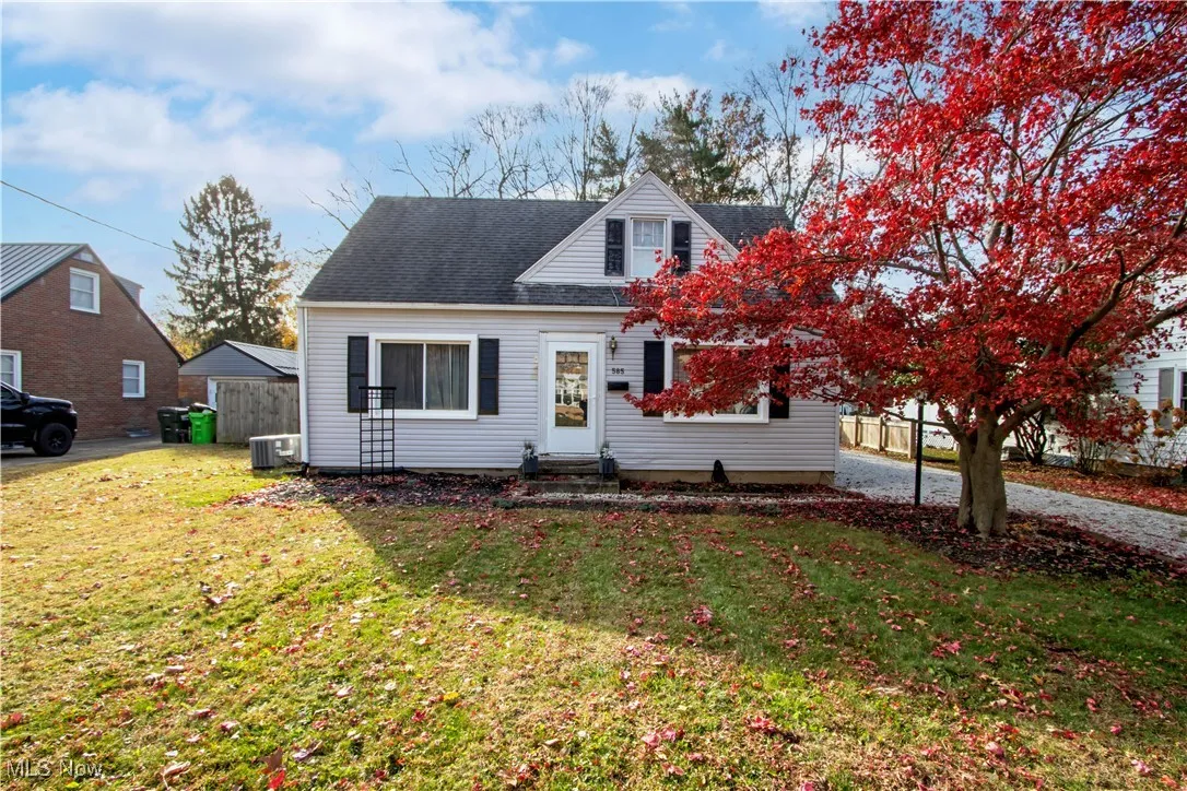 View of front facade with a shingled roof and entry steps