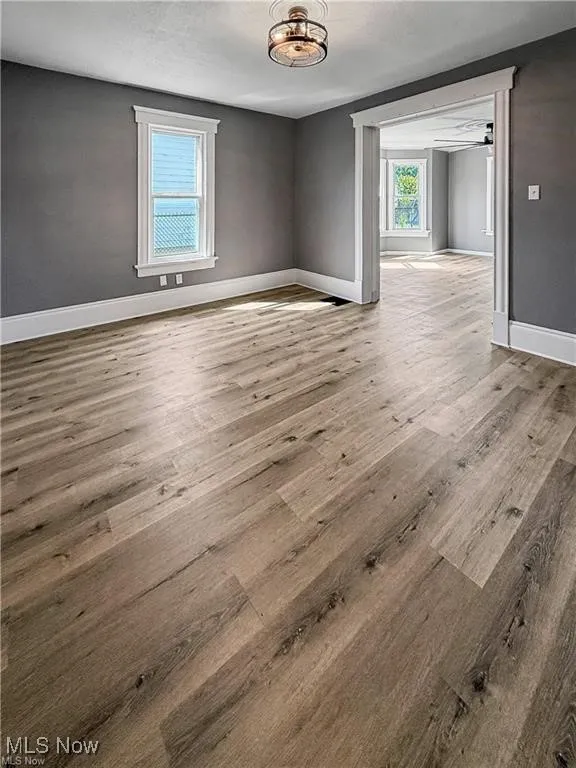 Empty room with light wood-type flooring and a textured ceiling
