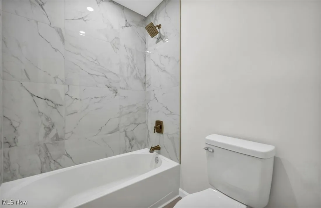 Bathroom with bathing tub / shower combination and toilet