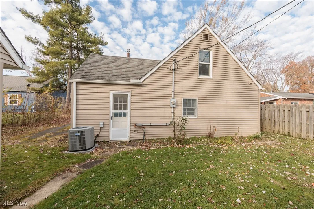 Rear view of property with a shingled roof