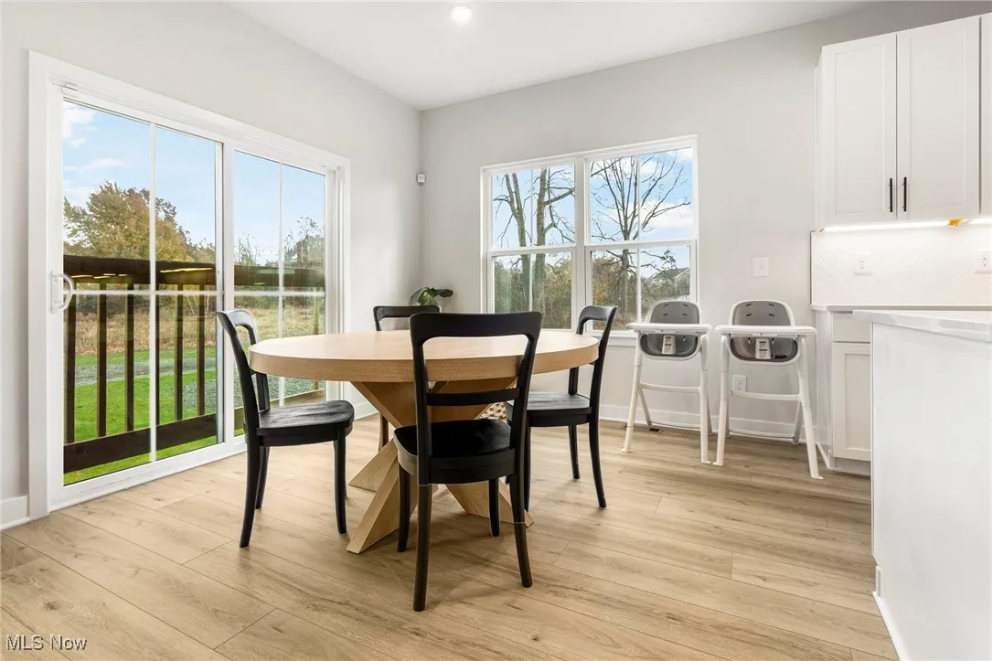 Dining area featuring light wood-style flooring and recessed lighting