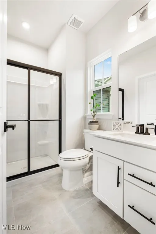 Bathroom featuring vanity and a stall shower