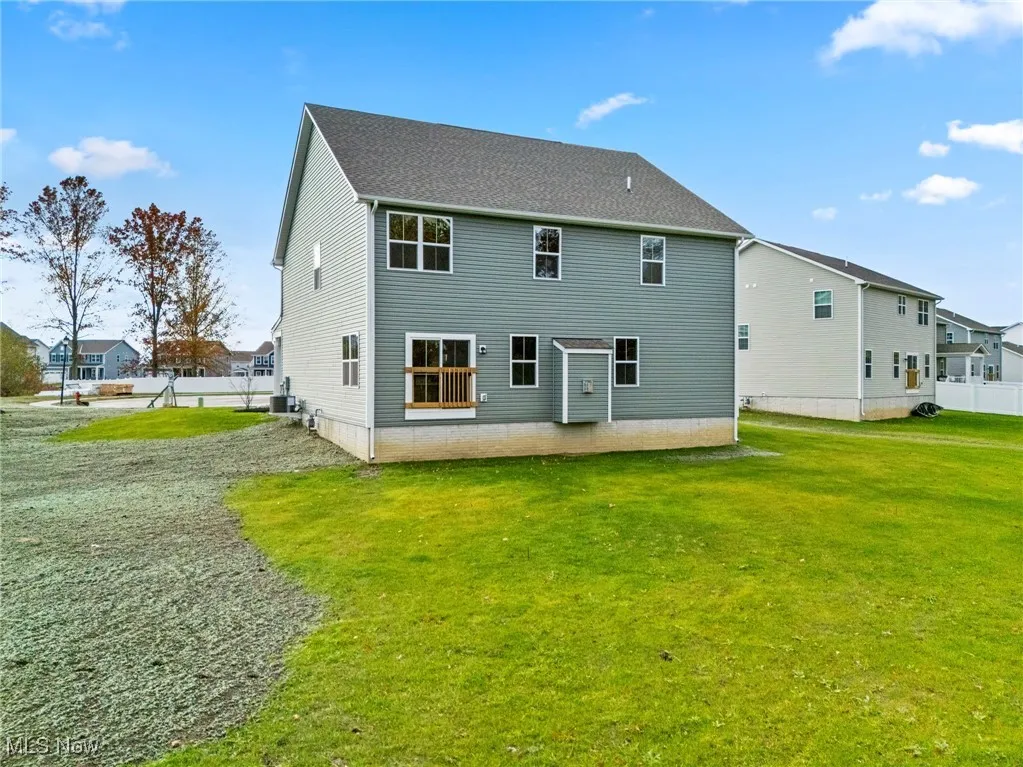 Back of property featuring a residential view