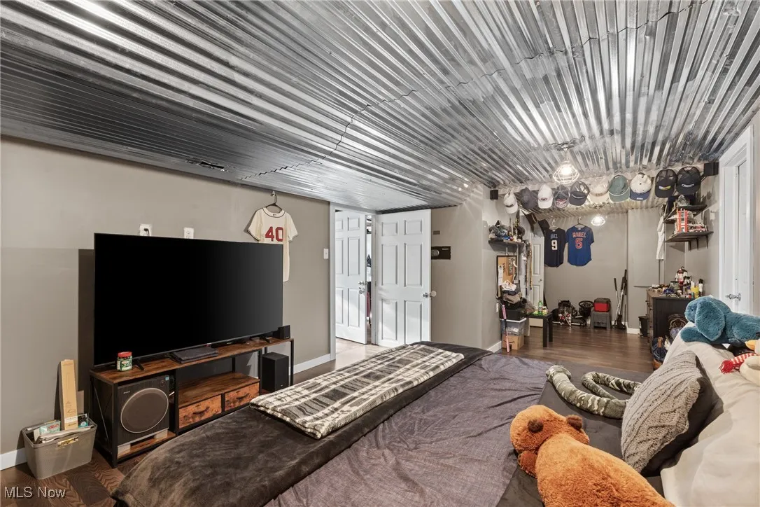 Bedroom with wood finished floors and baseboards