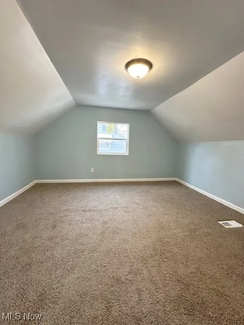 Bonus room with lofted ceiling and carpet floors