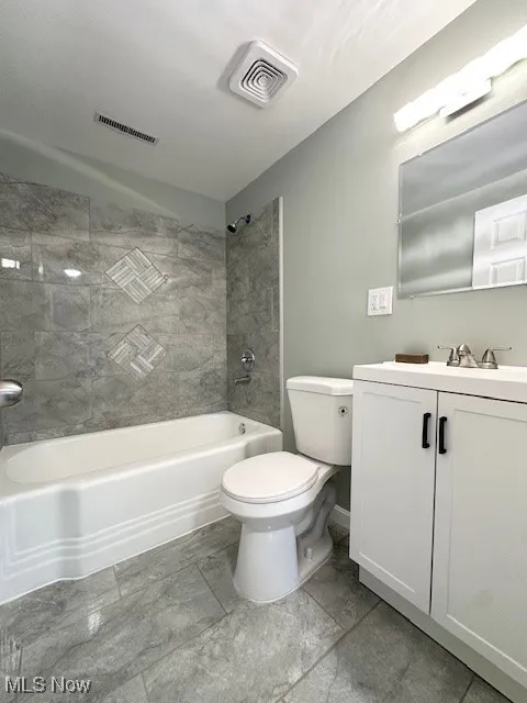 Bathroom with vanity and shower / washtub combination