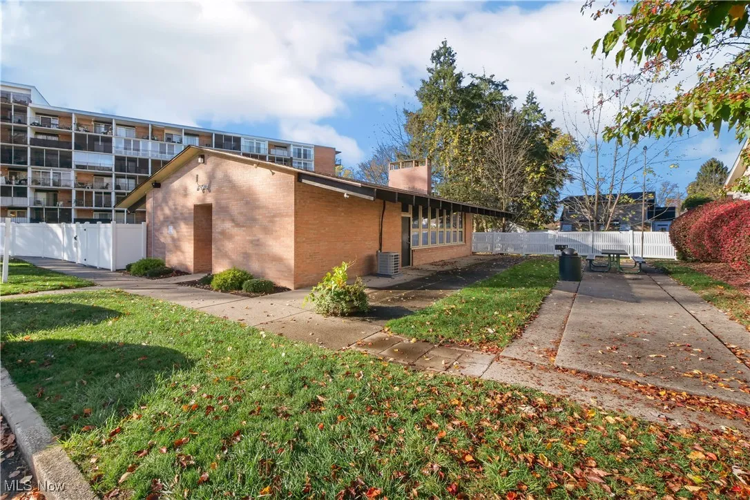 Rear view of house with brick siding and a chimney