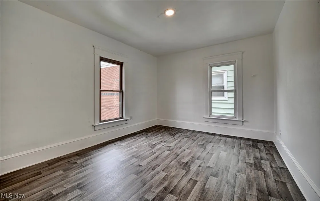 Spare room featuring wood finished floors