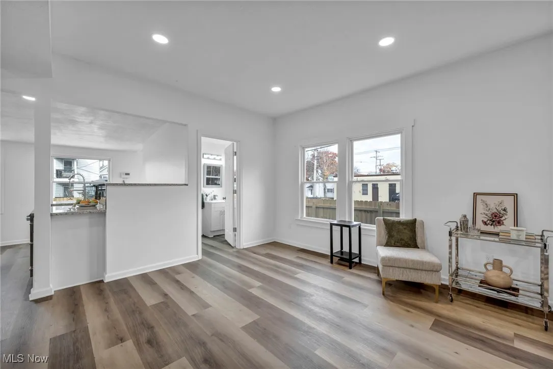 Living area with recessed lighting and light wood finished floors