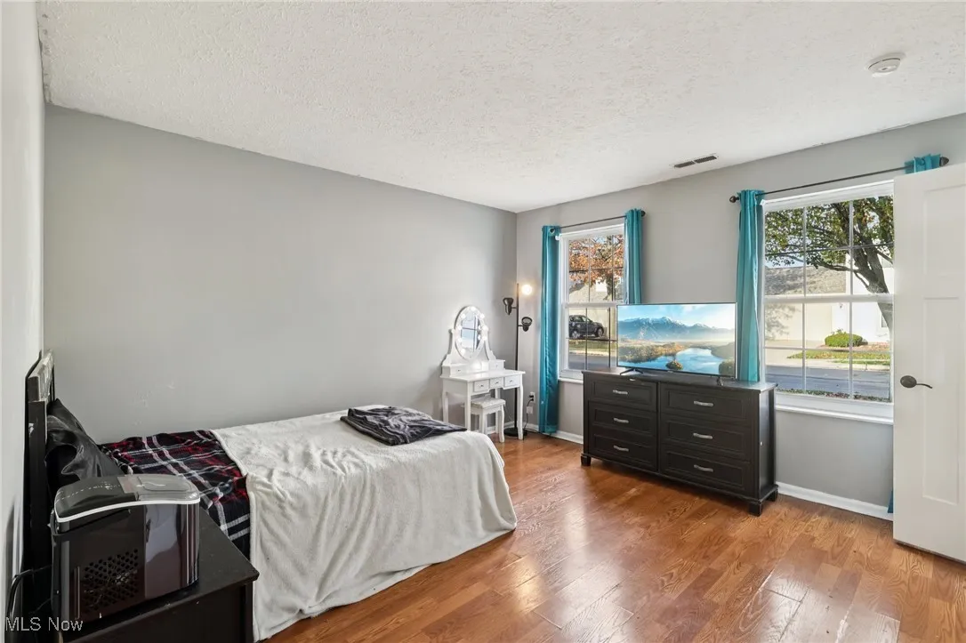 Bedroom featuring light wood-style flooring and a textured ceiling