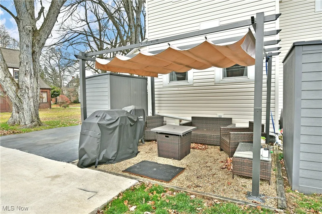 View of patio featuring an outdoor living space and a grill