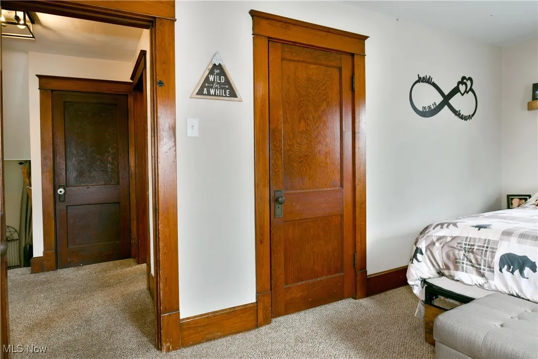 Bedroom with carpet floors and baseboards