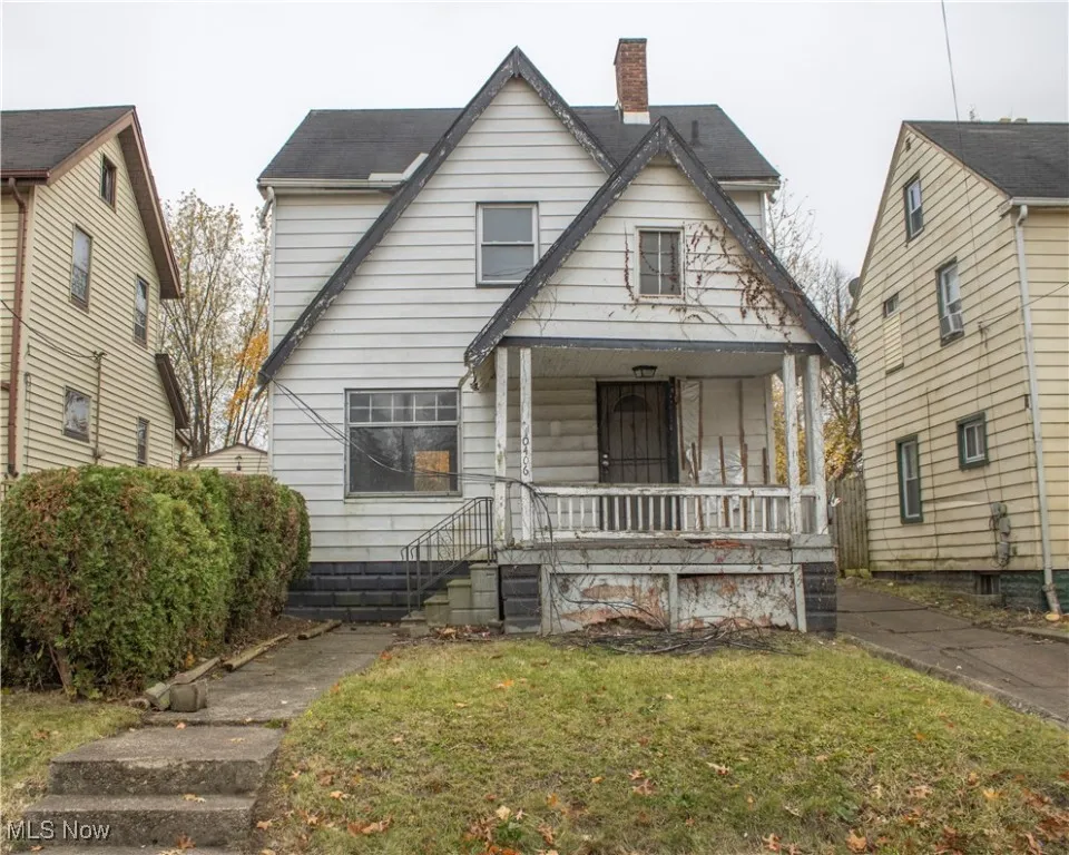 Bungalow-style house featuring a porch, a chimney, and a front lawn