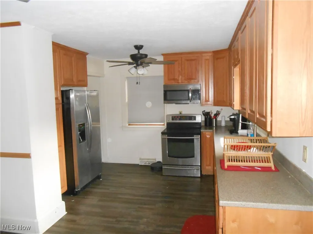 Kitchen featuring stainless steel appliances, Corian counter tops with undermount sink