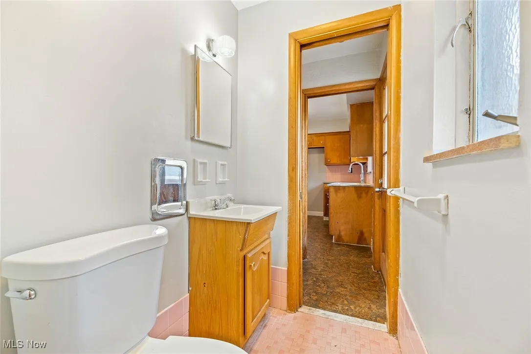 Half bath between the kitchen entry and primary bedroom