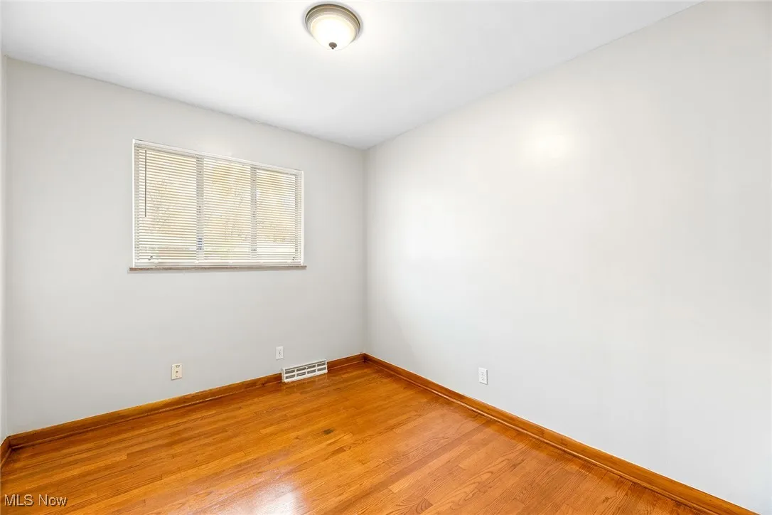 Bedroom featuring light wood finished floors and baseboards