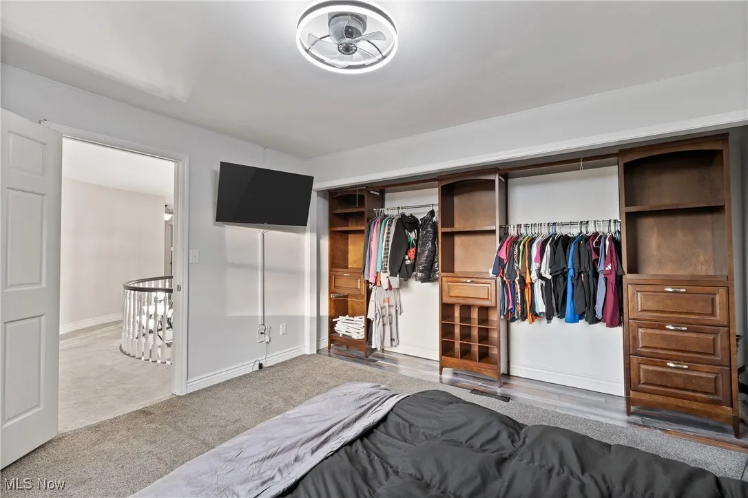 Carpeted bedroom with a closet and baseboards