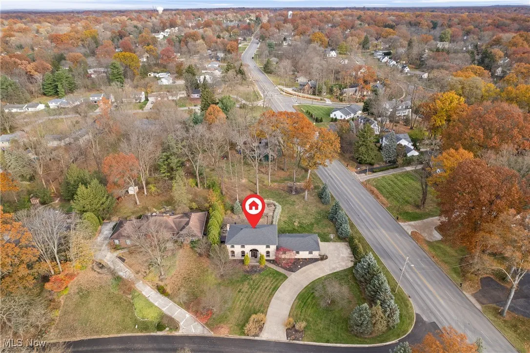 Aerial overview of property's location with a tree filled landscape