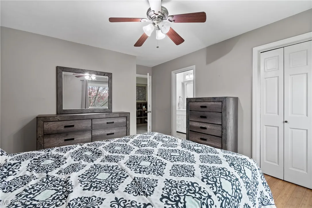 Bedroom featuring a closet, light wood-style floors, and ceiling fan