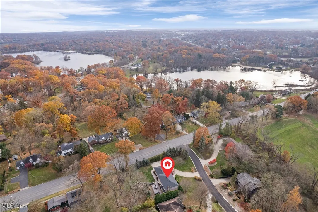 Aerial overview of property's location with a large body of water and a forest