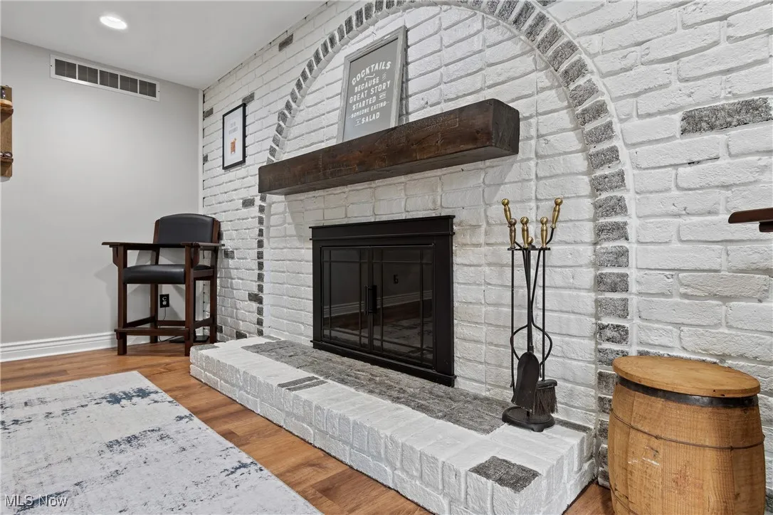 Living area with wood finished floors and a fireplace
