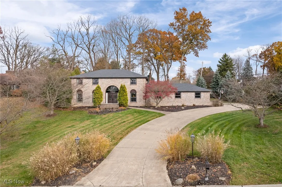 View of front of property with a front lawn and stone siding