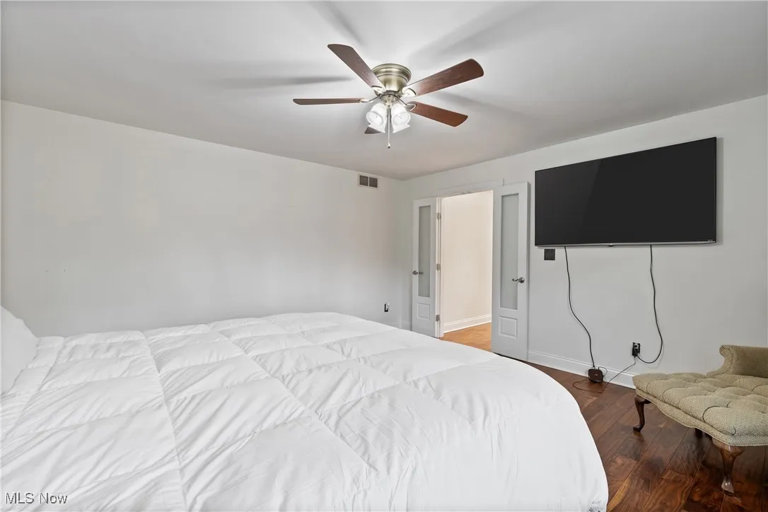 Bedroom featuring wood finished floors and ceiling fan