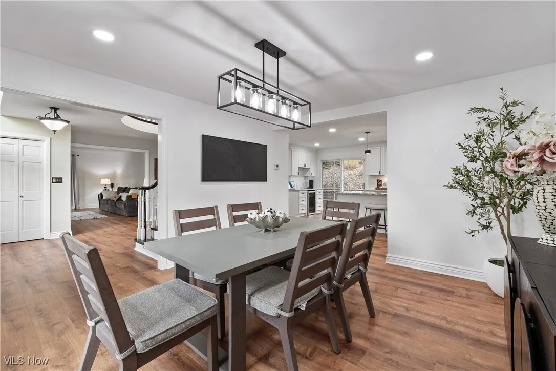 Dining area featuring recessed lighting and dark wood-style floors