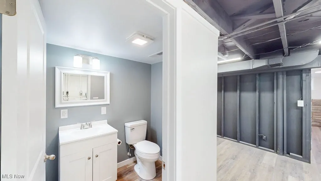 Half bath with luxury vinyl plank flooring.