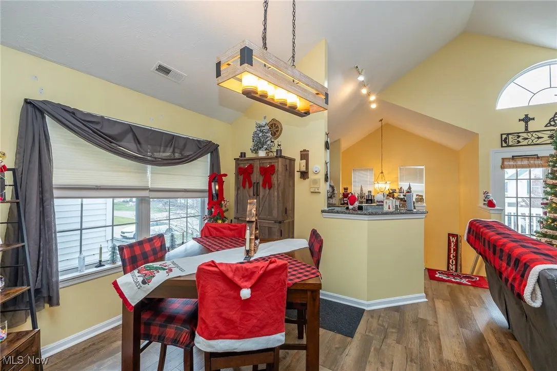 Dining room with lofted ceiling and wood finished floors