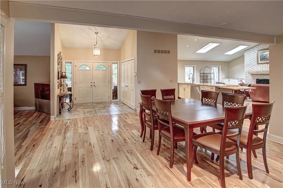 Diming room looking into front entry (strait), kitchen (right), living room (left).