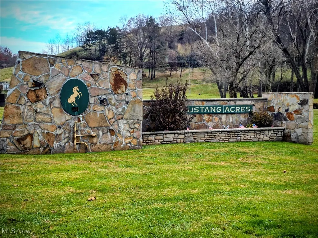 Community / neighborhood sign with a yard