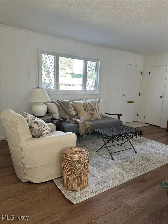 Living room with luxury Vinyl floors, natural light and a textured ceiling