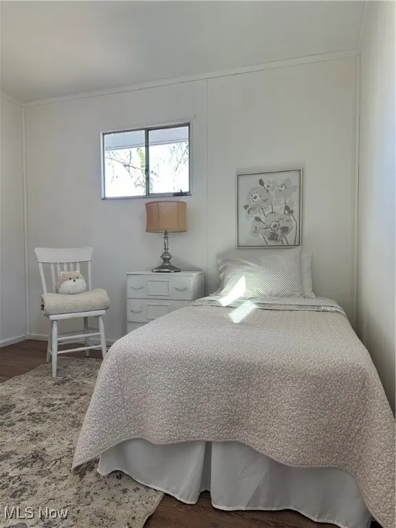 Bedroom #1 with Luxury Vinyl floors and crown molding