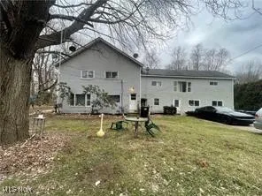 Rear view of property featuring a lawn