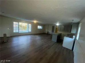 Unfurnished living room with dark wood-style floors