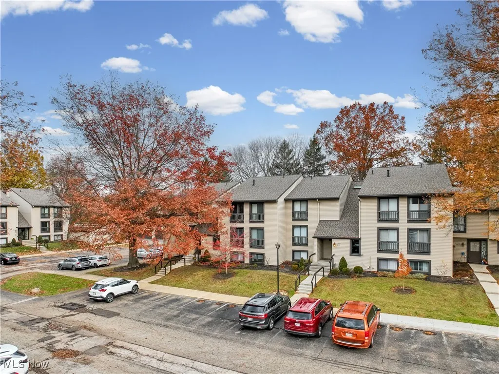 View of property with uncovered parking