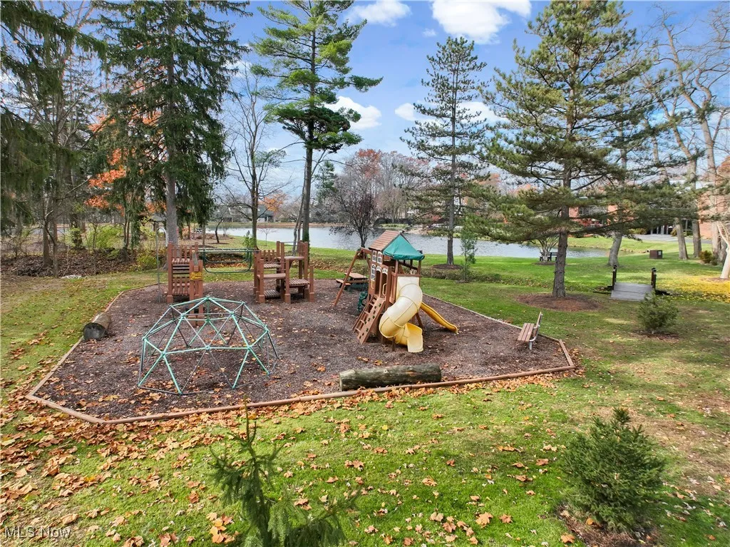 Community jungle gym featuring a yard and a water view